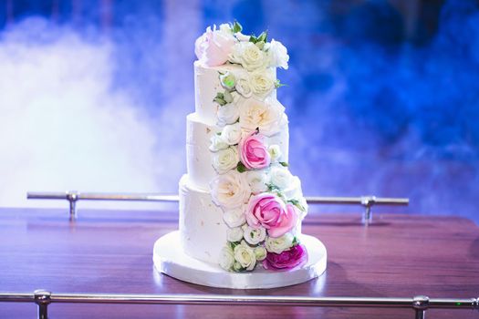 Beautiful wedding cake for the newlyweds at the wedding. A birthday cake at a banquet.