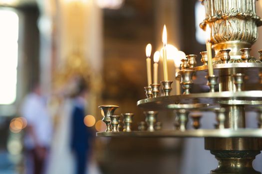 Close-up of candles in the church before the wedding ceremony.