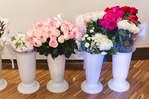 Vases with bouquets of flowers. storage of donated flowers at a banquet in a restaurant.