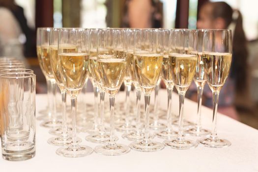 Bride and groom champagne glasses at a wedding reception.