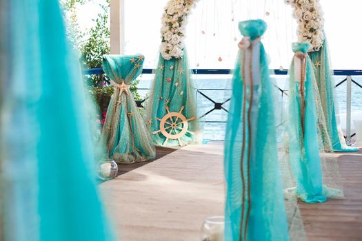 Wedding on the beach. Beautiful wedding arch, decorated with flowers. Sea. The ocean.