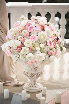 Details. Wedding ceremony in the open air of fresh flowers, with candles. Gentle and beautiful wedding decor for newlyweds.