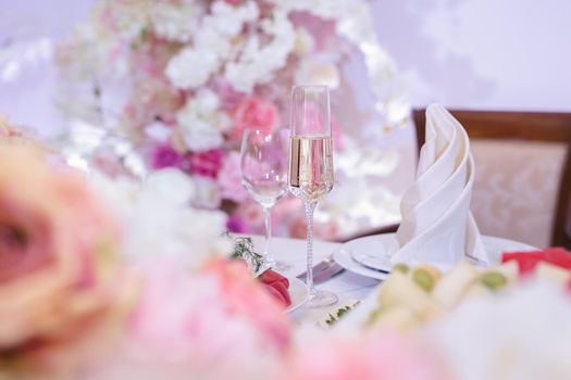 Bride and groom champagne glasses at a wedding reception.