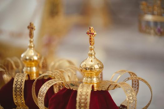 Wedding golden crowns ready for wedding ceremony in orthodox church.