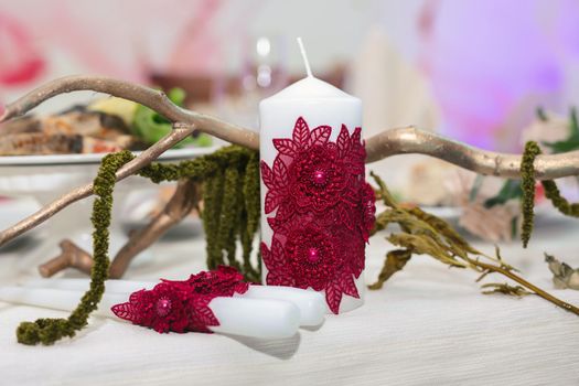 Wedding candles for the family hearth on the festive table.