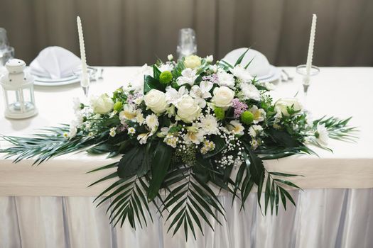 Wedding floral decor in white at a banquet in a restaurant.