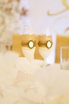 Decorated bottles of champagne on the newlyweds table