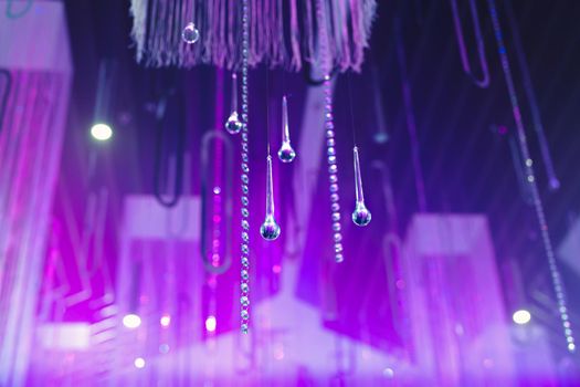 Hanging glass and shiny beads are an element of the wedding decor.