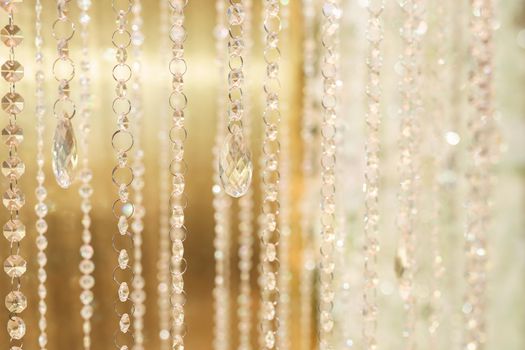 Hanging glass and shiny beads are an element of the wedding decor.