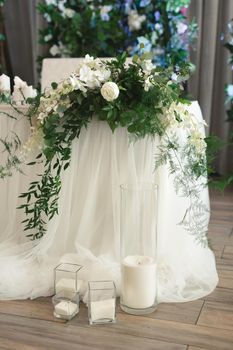 Beautiful wedding table decor of the bride and groom: flowers and candles.