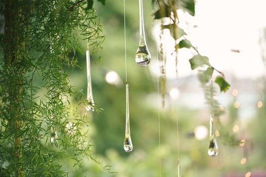 Hanging glass and shiny beads are an element of the wedding decor.