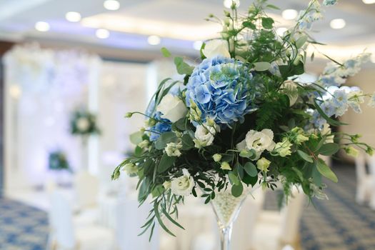 Table setting at a luxury wedding reception. Beautiful flowers on the table.