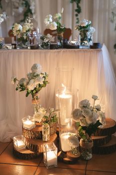 Lighted candles placed on wooden logs - Natural and romantic wedding ceremony decoration