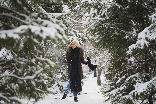 Beautiful woman posing in a winter forest.