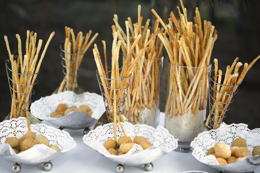 Breadsticks and snacks on the buffet table.