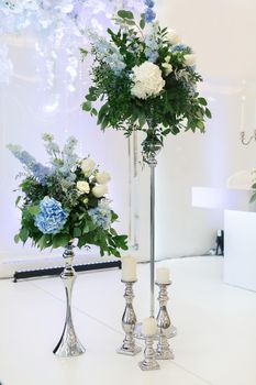 Table setting at a luxury wedding reception. Beautiful flowers on the table.