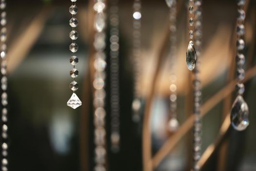 Details of the wedding ceremony made of fresh flowers, sparkling beads. Delicate and beautiful wedding decor for newlyweds.