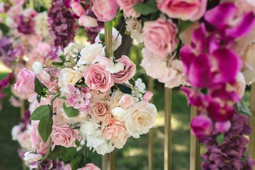 Details. Wedding ceremony in the open air of fresh flowers, with candles. Gentle and beautiful wedding decor for newlyweds.