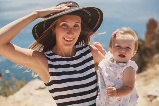 Beautiful mother and daughter on the mountain