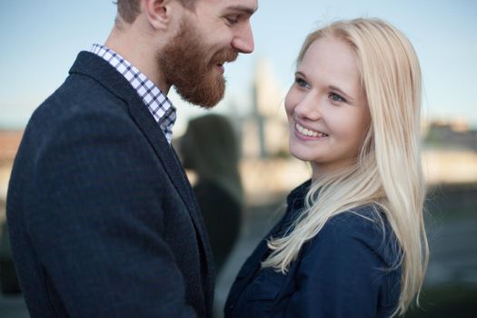 A man and a woman smile at each other