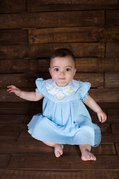 Beautiful girl in blue dress on wooden background