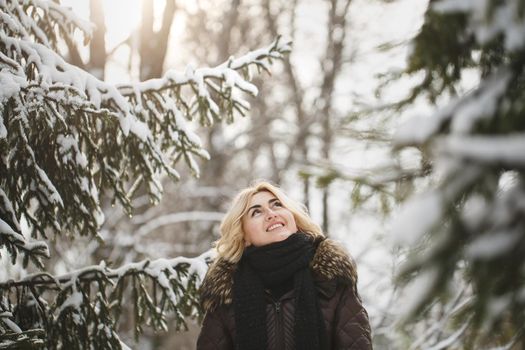 Beautiful woman posing in a winter forest.