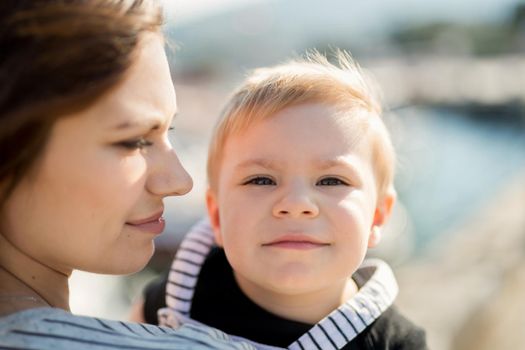 Happy mother and son on sea yacht background