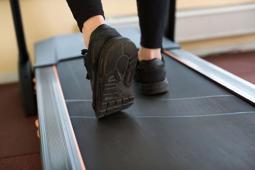 Man running in a gym on a treadmill