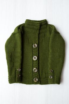 Knitted children's sweater on a white background