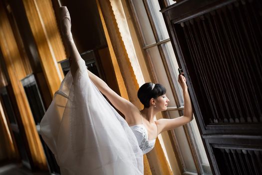 Adult ballerina practicing in the hall of the theatre