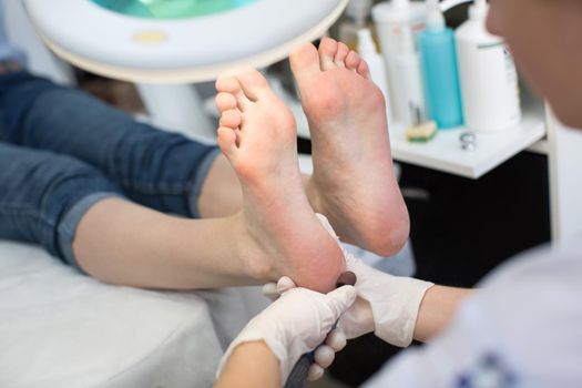 The pedicure process in close-up, polishing the feet in the beauty salon