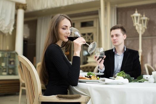 Beautiful woman drinking wine at the restaurant