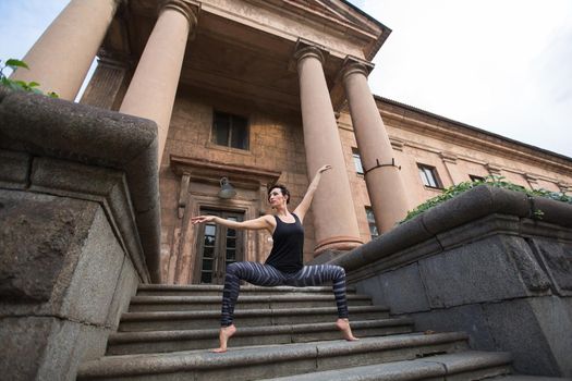 Beautiful ballerina dancing on the street near the theater