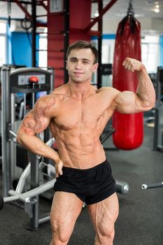 Bodybuilder posing for the camera in the gym