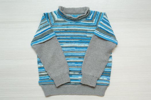 Knitted children's sweater on a white background