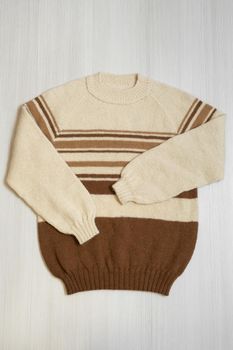 Knitted men's sweater on a white background