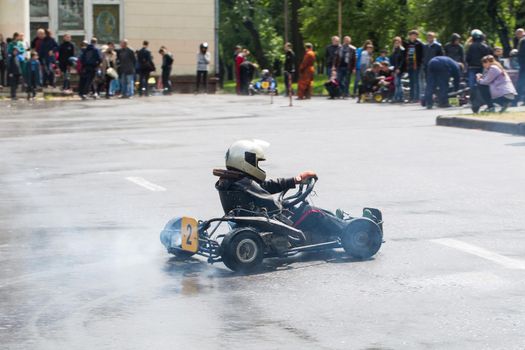 Karting - driver in helmet on kart circuit