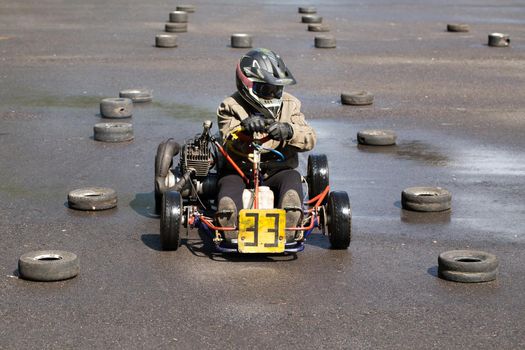 Karting - driver in helmet on kart circuit