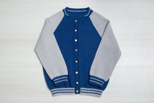 Knitted children's sweater on a white background