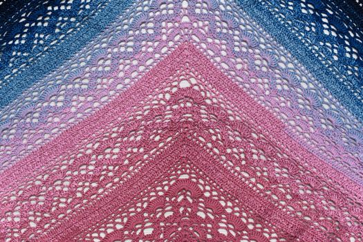 Knitted scarf pink and blue on a white background