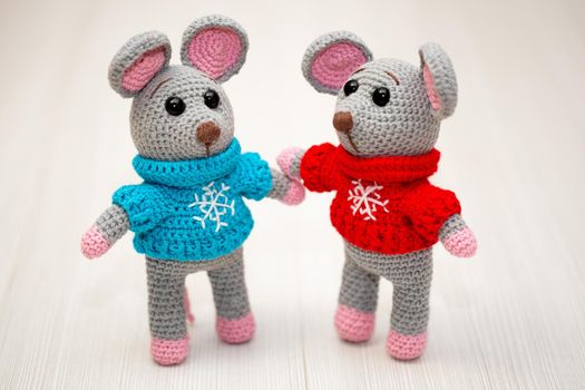 A knitted mouse. A soft toy as a symbol of the New Year.