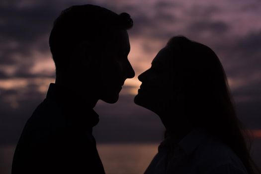 Couple in love silhouette during sunset - touching noses