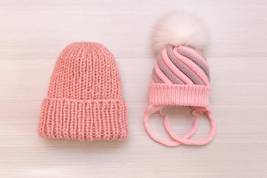 Two pink knitted hats on a white background