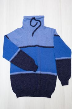 Knitted children's sweater on a white background