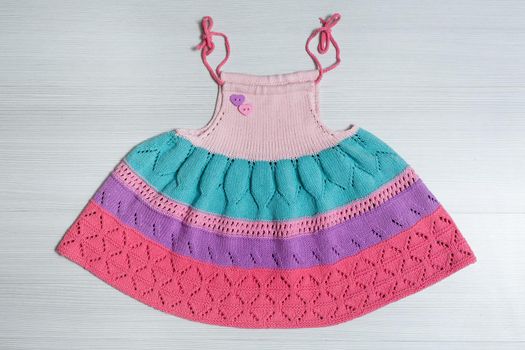 Knitted wool dress for a child on a white background