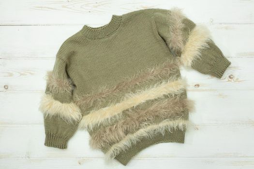 Knitted children's sweater on a white background
