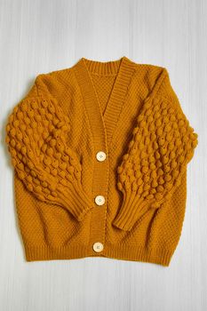 Knitted children's sweater on a white background