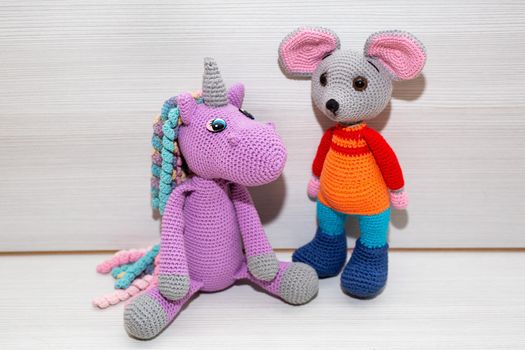 A knitted mouse. A soft toy as a symbol of the New Year.