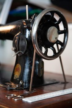 Old antique sewing machine. Retro tailor workshop.