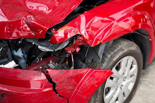 Red Car crash background. Front of red car get damaged by accident on the road
